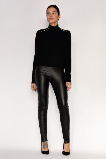 woman wearing black leather pants with a black top and high heels