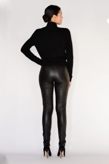 woman wearing black leather pants with a black top and high heels back view