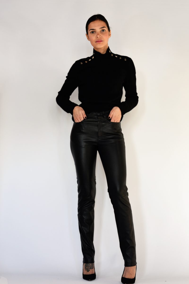 woman wearing black leather pants with a black top front view