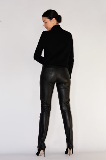 woman wearing black leather pants with a black top back view