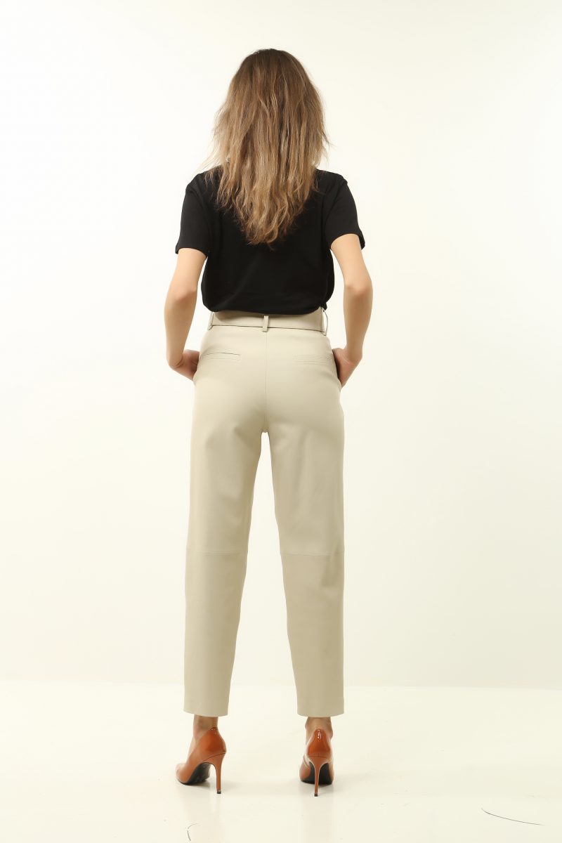 woman wearing white leather pants on white background