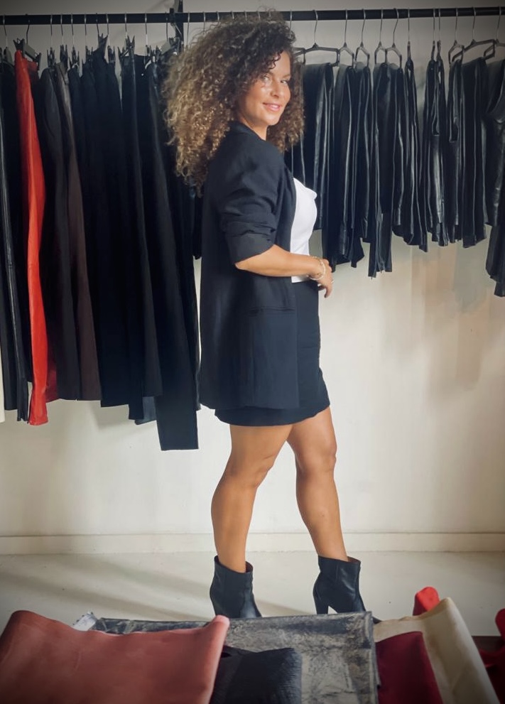 Amira Douiri standing next to her handmade leather pants