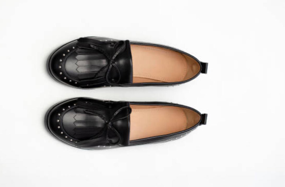 Black loafers on white background