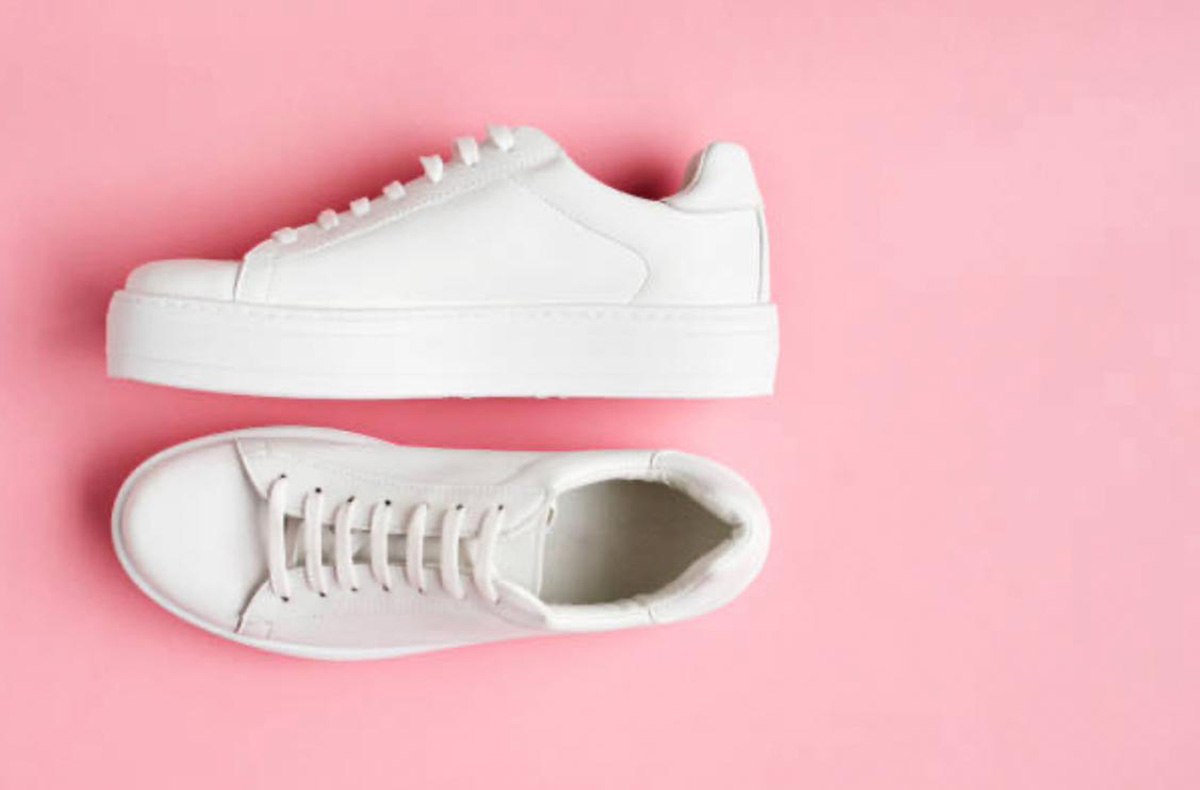 White sneakers on pink background