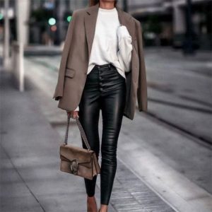 woman wearing black leather pants walking on the street